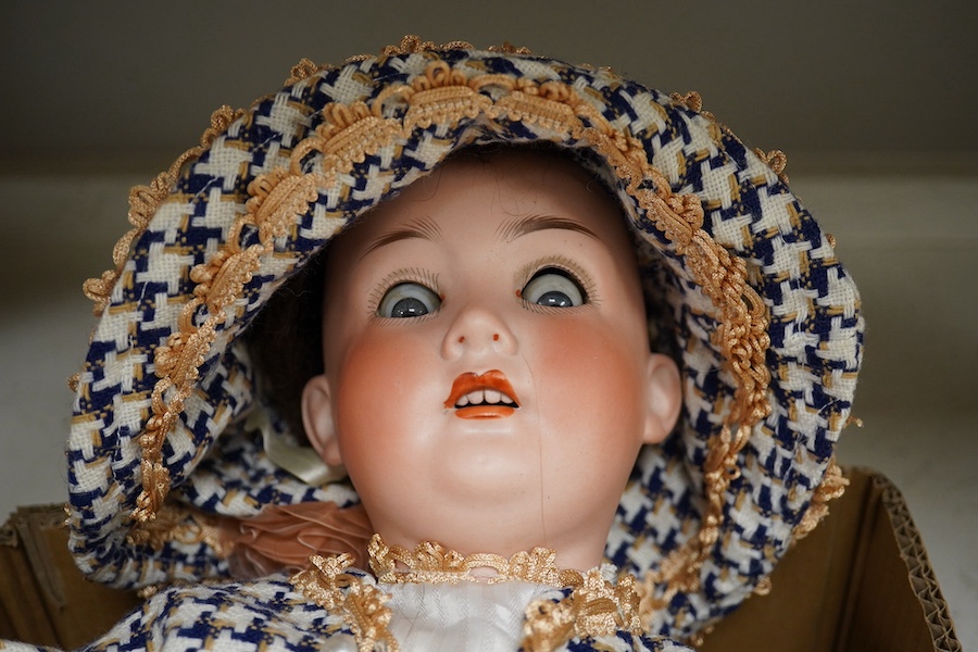 A stamped, Trebor Germany 22, bisque headed, open mouthed doll. 60cm long. Condition - fair to good